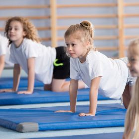Children exercising on gymnastics mats