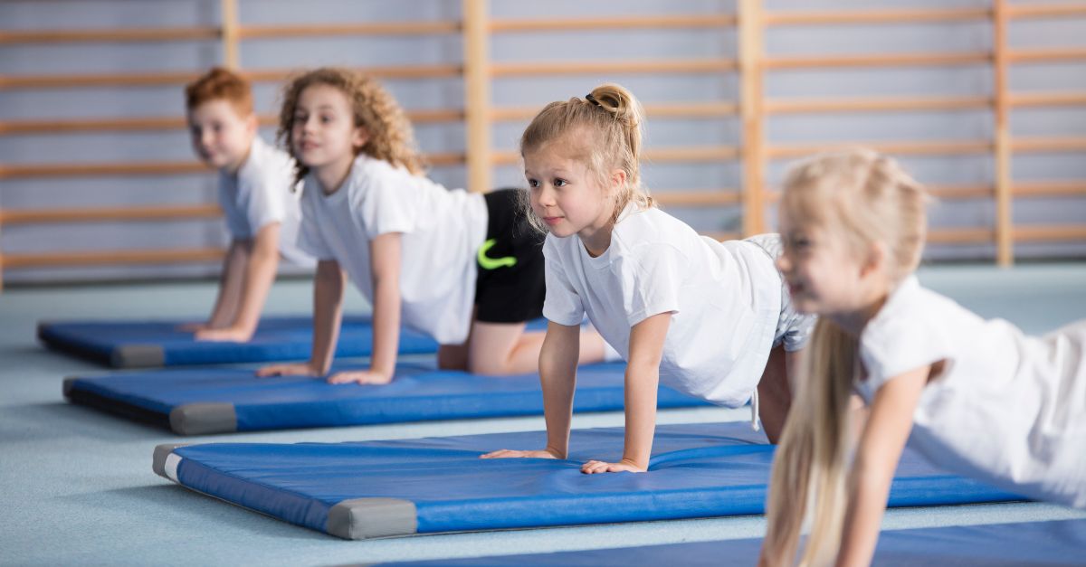 Children exercising on gymnastics mats