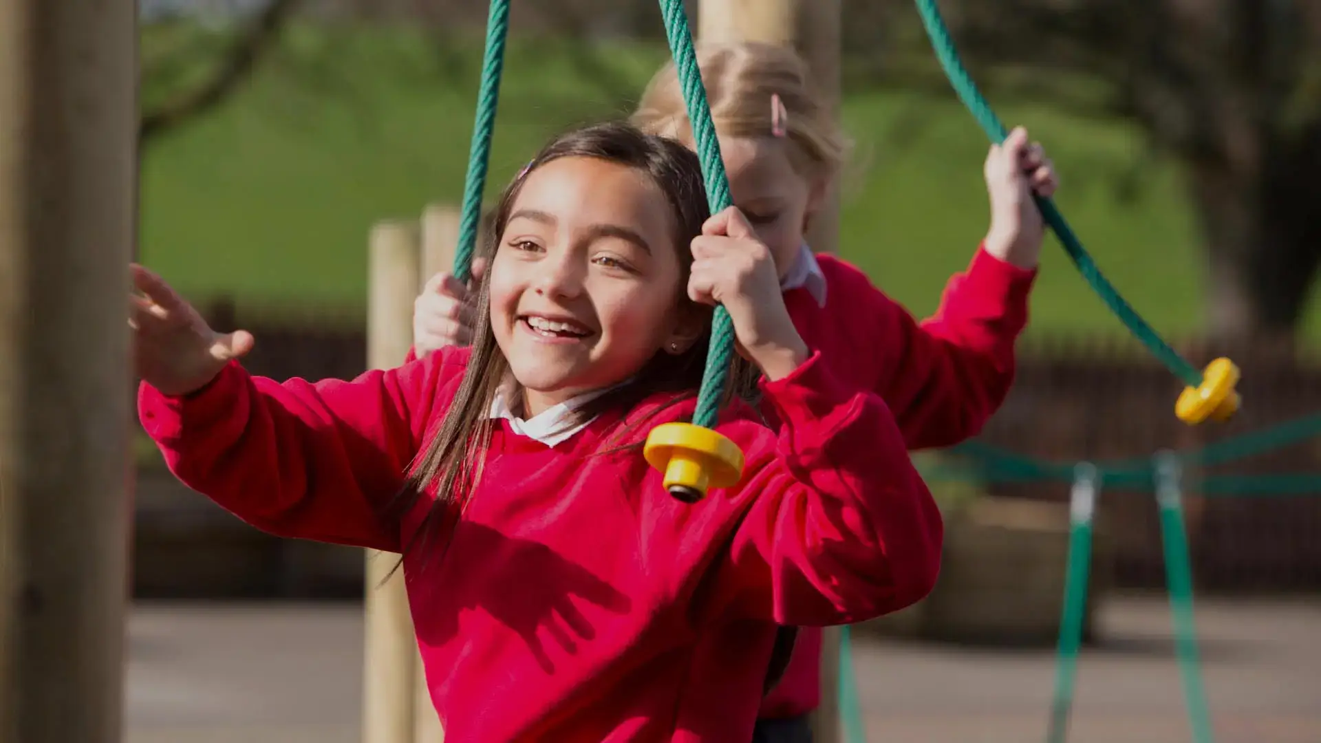 A child on a swing in a school playground