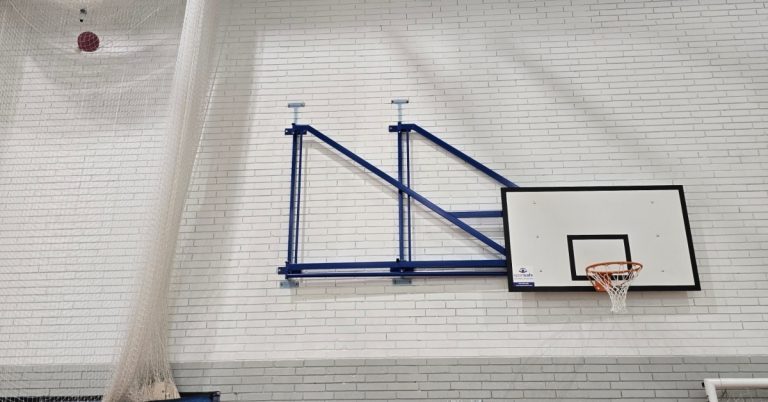 Basketball on sports hall wall