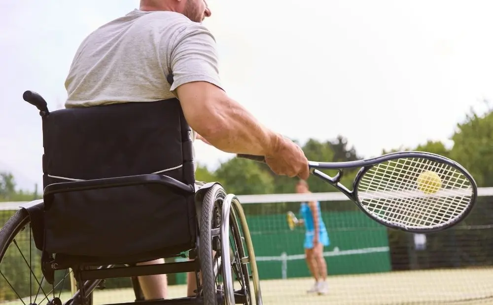 Wheelchair user playing tennis