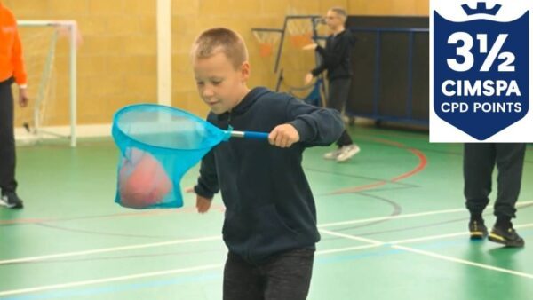 Child playing in a sports hall with a blue net
