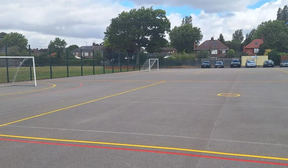 Football goals on a concrete MUGA with colourful line markings