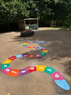 Alphabet Snake in multicolour on a playground
