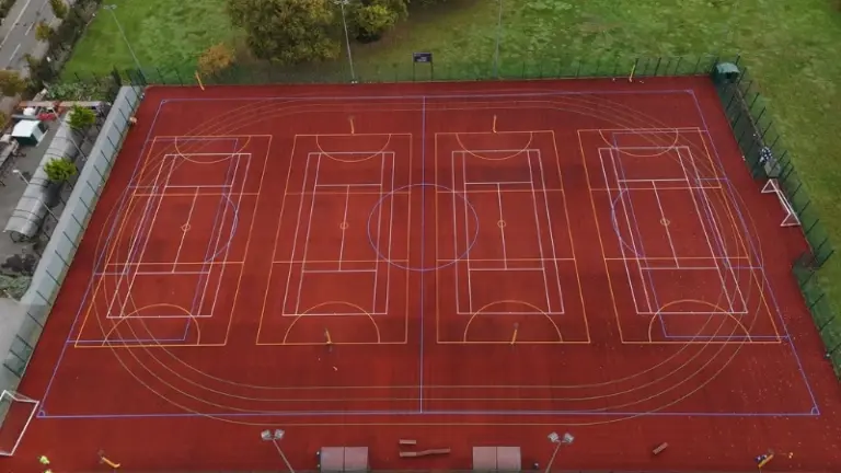 Red MUGA with basketball markings painted on