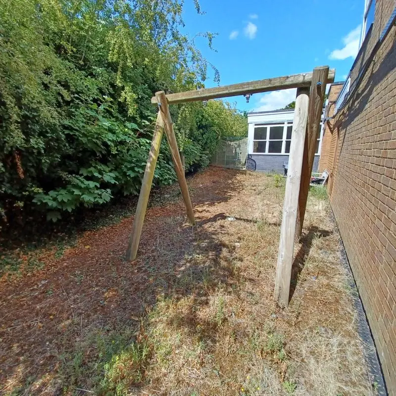 Grassy area with broken swing
