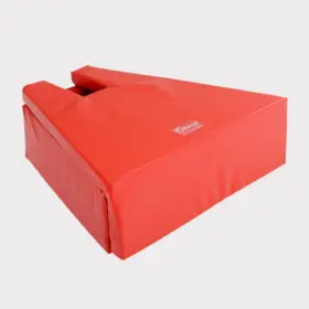 Bright red, wedge-shaped foam tackle shield on a light gray background. Curved cutout at the top; a logo is visible. Durable, athletic equipment.