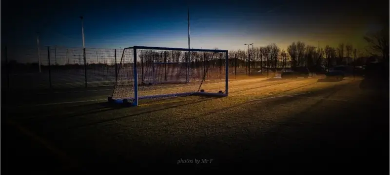 Football goal on artificial grass with unrise